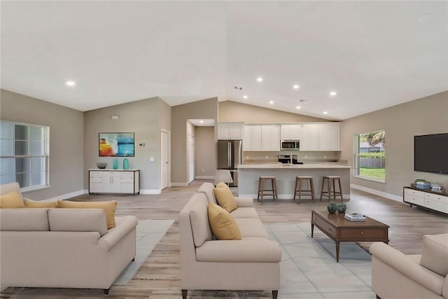 11126 Roseland Rd, Sebastian, FL 32958 - living area featuring recessed lighting, vaulted ceiling, baseboards, and light wood-style flooring