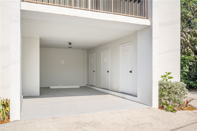 view of exterior entry with a balcony