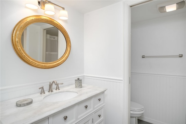 bathroom featuring vanity and toilet