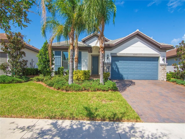 ranch-style house featuring a garage and a front lawn