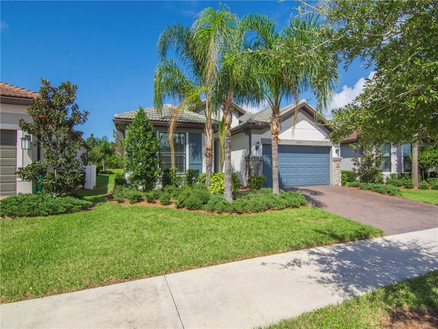 view of front of home featuring a garage and a front yard