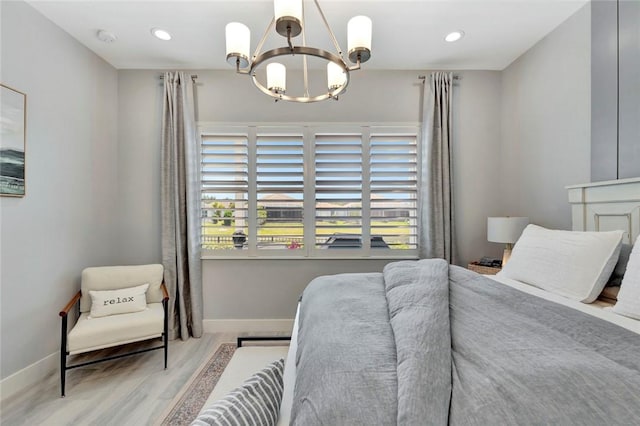 9378 Orchid Cove Cir, Vero Beach, FL 32963 - bedroom with wood finished floors, a chandelier, baseboards, and multiple windows