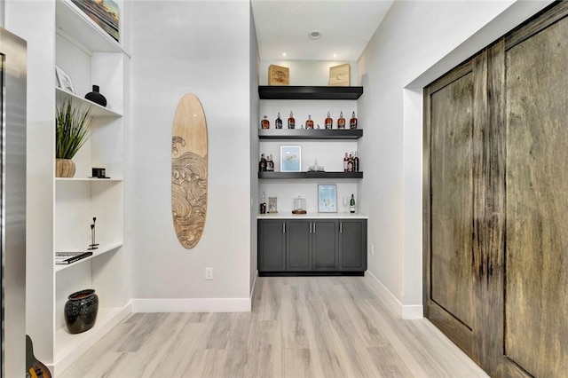 9378 Orchid Cove Cir, Vero Beach, FL 32963 - bar featuring baseboards and light wood-style floors