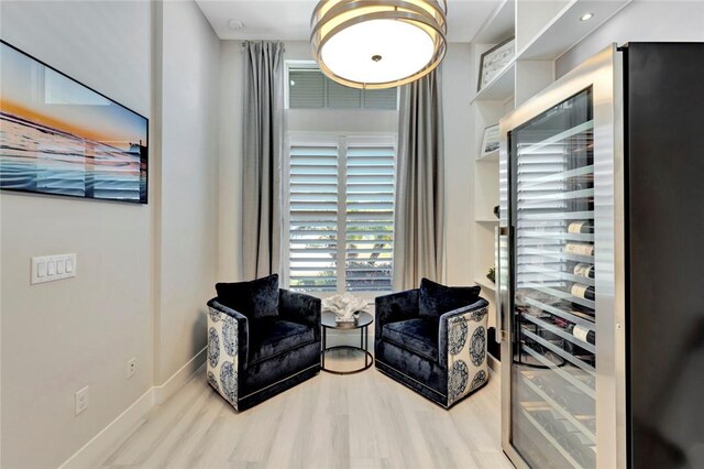 9378 Orchid Cove Cir, Vero Beach, FL 32963 - sitting room featuring wood finished floors, wine cooler, and baseboards