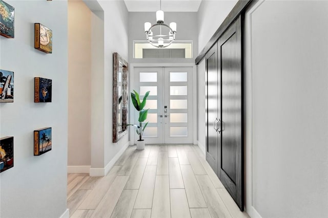 9378 Orchid Cove Cir, Vero Beach, FL 32963 - entrance foyer with a notable chandelier, light wood-style floors, french doors, and baseboards