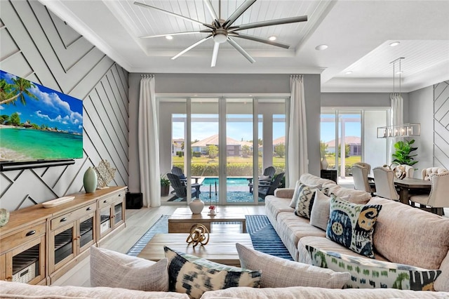 9378 Orchid Cove Cir, Vero Beach, FL 32963 - living room featuring a raised ceiling and ceiling fan with notable chandelier