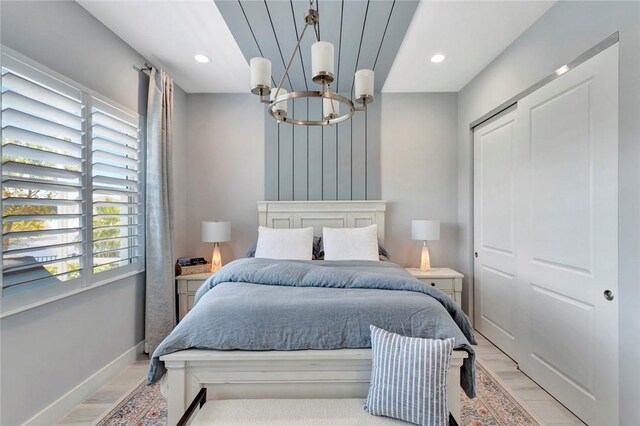 9378 Orchid Cove Cir, Vero Beach, FL 32963 - bedroom featuring recessed lighting, an inviting chandelier, and light wood-type flooring