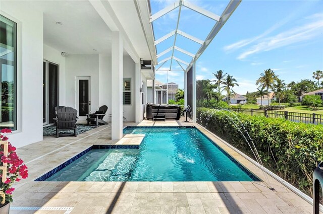 9378 Orchid Cove Cir, Vero Beach, FL 32963 - view of swimming pool featuring a patio, a fenced in pool, glass enclosure, and fence