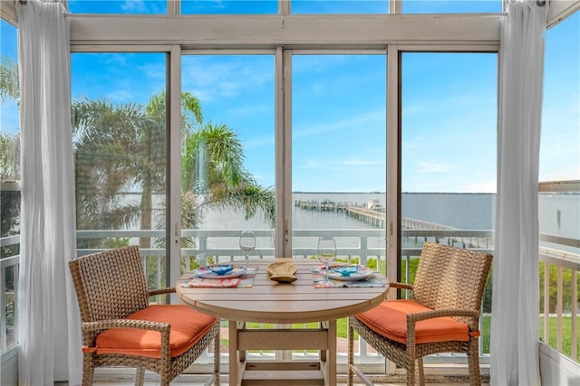 sunroom / solarium featuring a water view