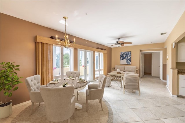 dining room featuring light tile patterned floors, baseboards, visible vents, and ceiling fan with notable chandelier