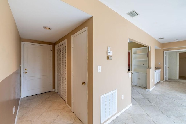 5035 Harmony Cir Unit 302, Vero Beach, FL 32967 - hallway with light tile patterned floors, baseboards, and visible vents