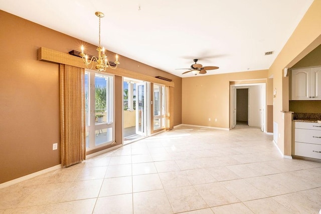 5035 Harmony Cir Unit 302, Vero Beach, FL 32967 - interior space featuring baseboards, visible vents, light tile patterned flooring, and ceiling fan with notable chandelier