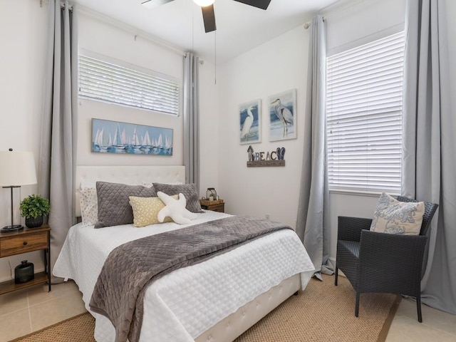 tiled bedroom featuring ceiling fan