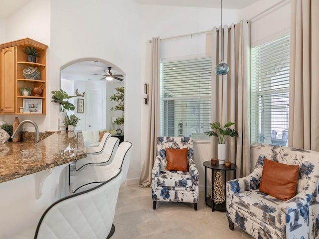 interior space with ceiling fan, sink, and vaulted ceiling