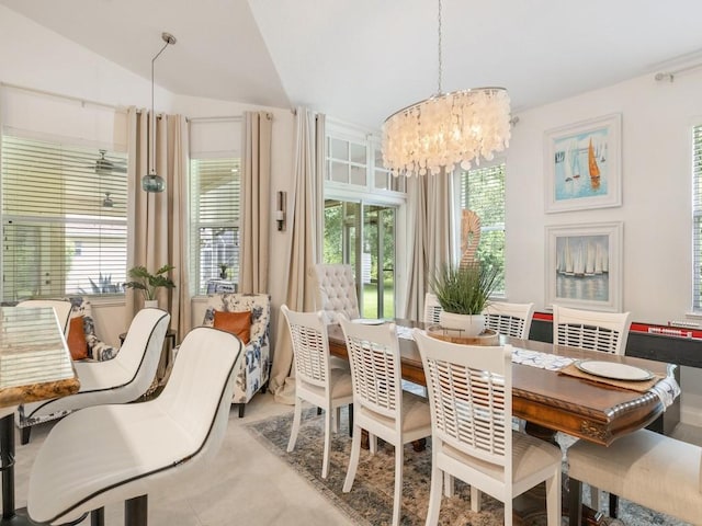 dining space with a chandelier and lofted ceiling