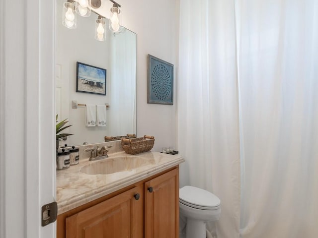 bathroom featuring toilet and vanity