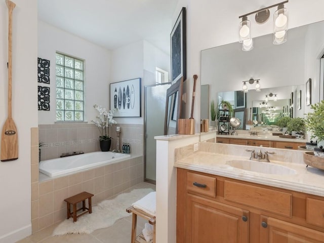 bathroom with tile patterned floors, vanity, and plus walk in shower