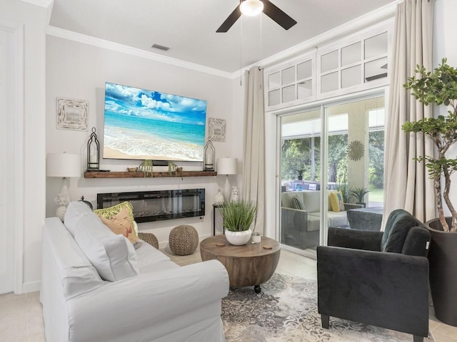 living room with ceiling fan, ornamental molding, and light tile patterned flooring