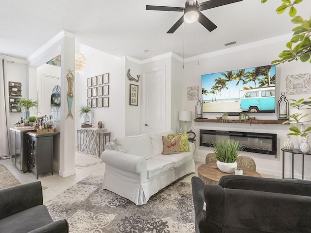 living room featuring ceiling fan and crown molding