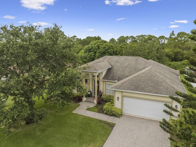 view of front of house featuring a garage and a front lawn