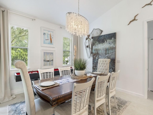 tiled dining space with a chandelier