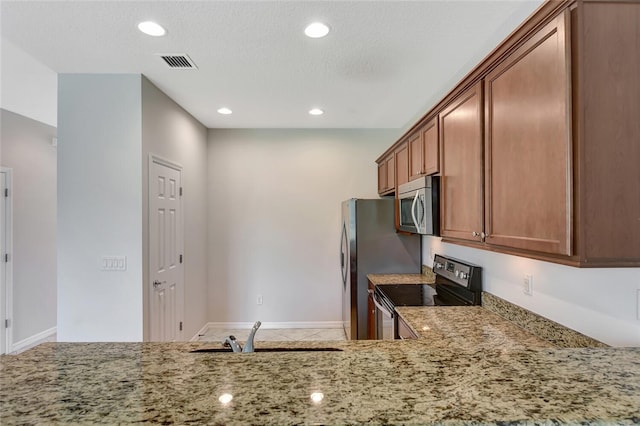 kitchen featuring black / electric stove, light stone counters, sink, and tile patterned flooring