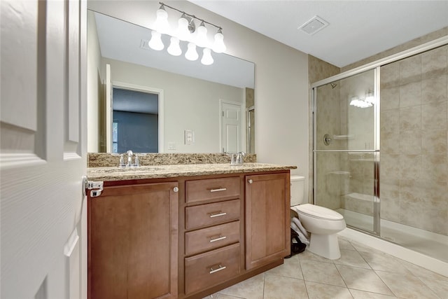 bathroom featuring tile patterned flooring, vanity, toilet, and walk in shower