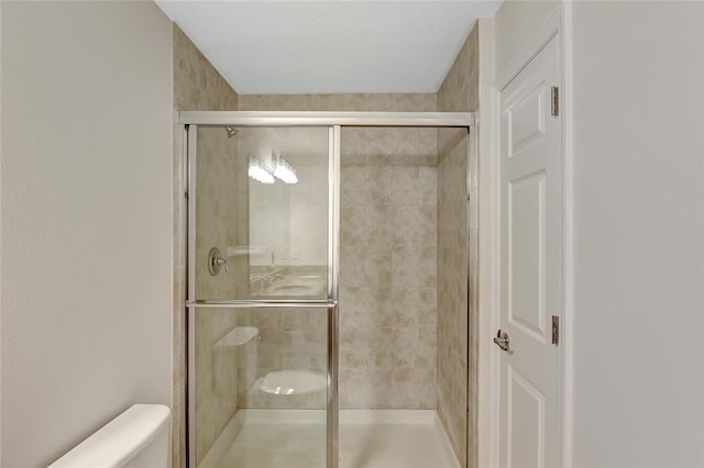 bathroom featuring toilet and walk in shower