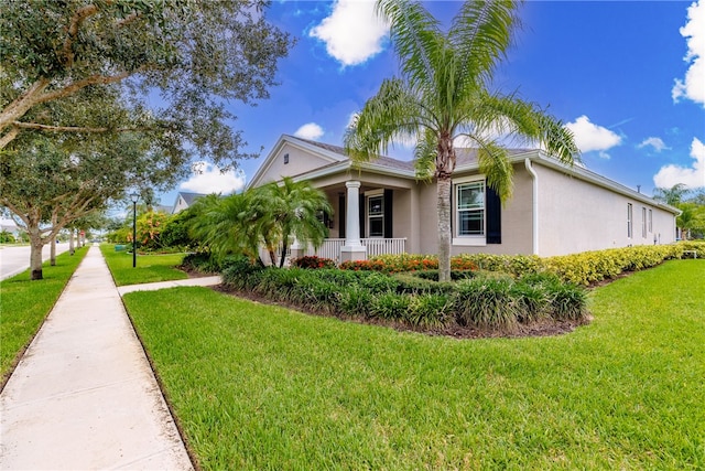 view of home's exterior featuring a lawn and covered porch