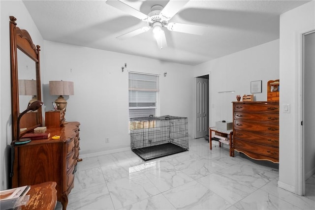 bedroom featuring a textured ceiling and ceiling fan