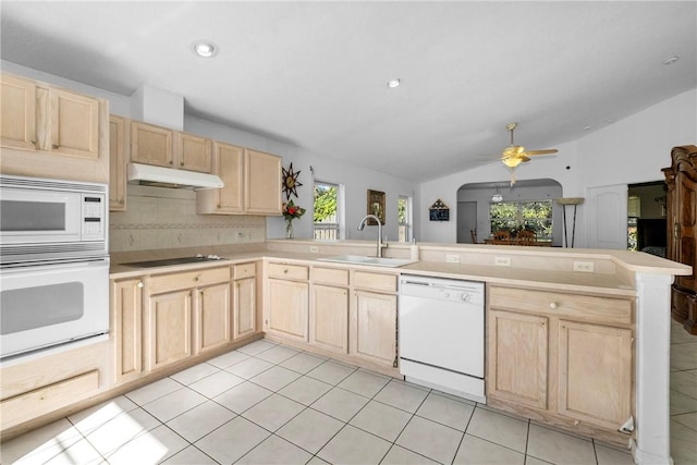 kitchen featuring kitchen peninsula, ceiling fan, decorative backsplash, white appliances, and sink