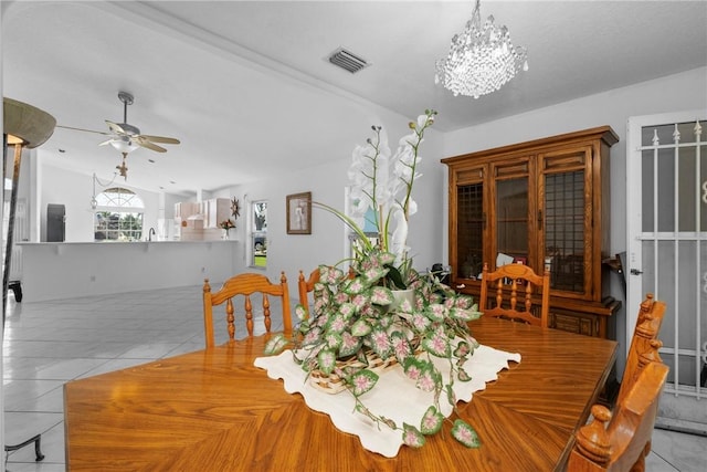 tiled dining area with ceiling fan and vaulted ceiling