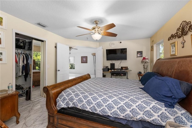 bedroom with ceiling fan, a closet, and multiple windows