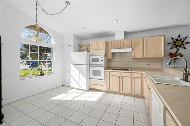 kitchen with pendant lighting, decorative backsplash, sink, white appliances, and light brown cabinets