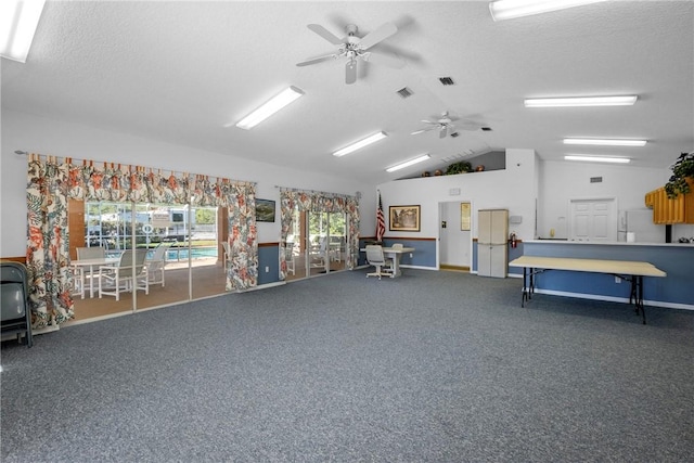 misc room with ceiling fan, a textured ceiling, carpet, and lofted ceiling