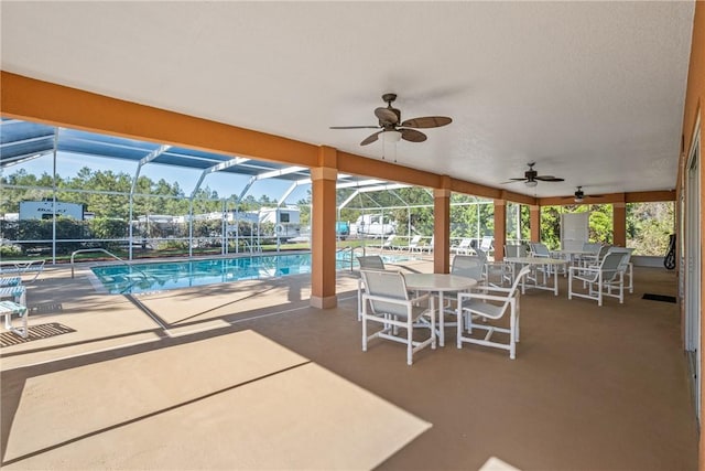 view of patio with ceiling fan and a lanai