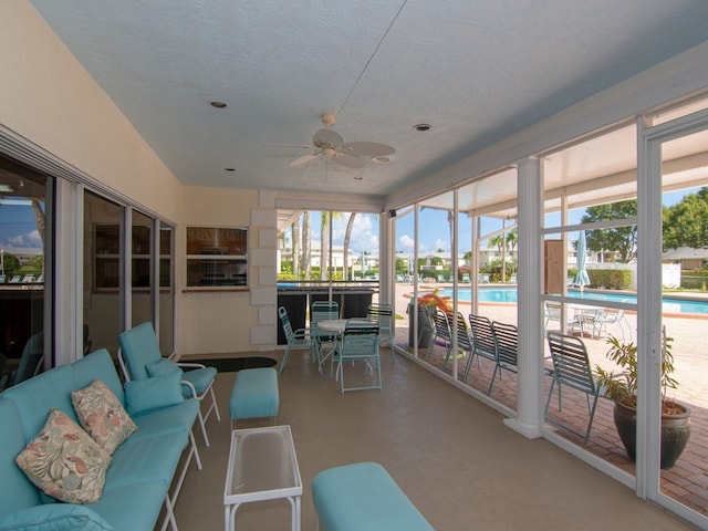 sunroom featuring ceiling fan