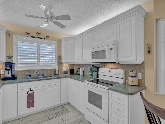 kitchen featuring white appliances, white cabinetry, and sink