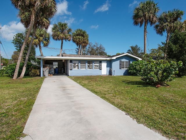 ranch-style home with a carport and a front lawn