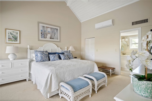 bedroom with ensuite bathroom, high vaulted ceiling, light colored carpet, a wall unit AC, and a closet