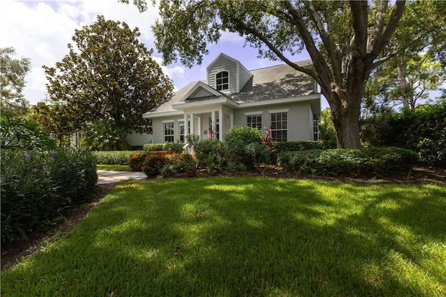 cape cod home with a front yard