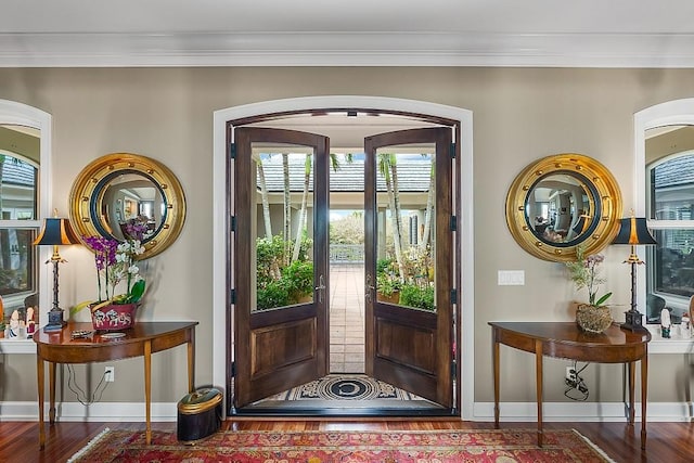 doorway featuring crown molding, french doors, and dark wood-type flooring