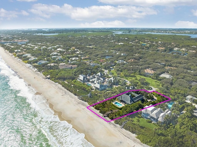 bird's eye view featuring a view of the beach and a water view