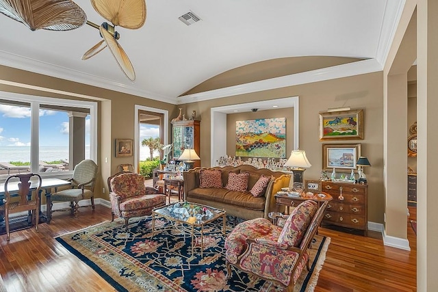 living room with ornamental molding, dark wood-type flooring, and vaulted ceiling