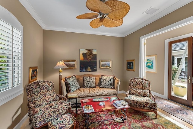 living room with crown molding and ceiling fan