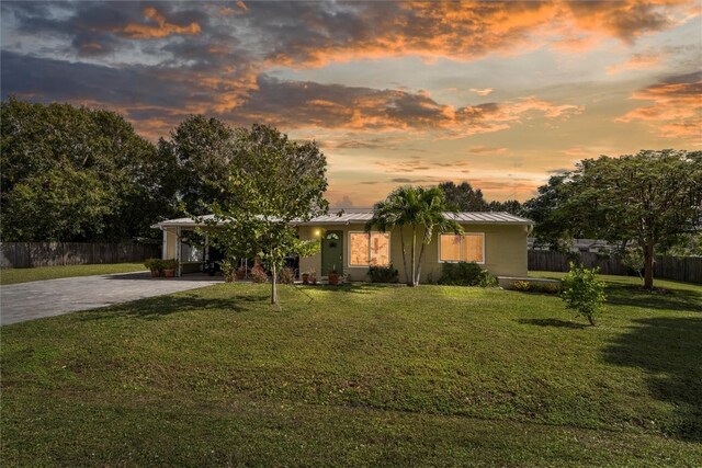 view of front of property with a yard and a carport