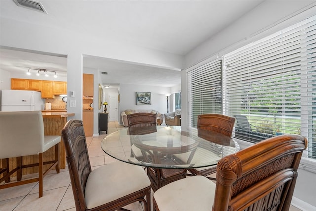 dining room with light tile patterned flooring and rail lighting