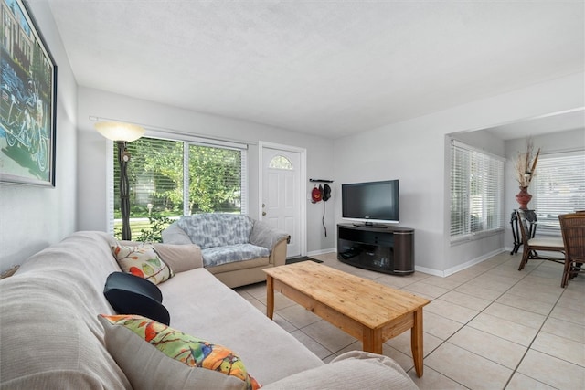 living room with light tile patterned floors and a healthy amount of sunlight