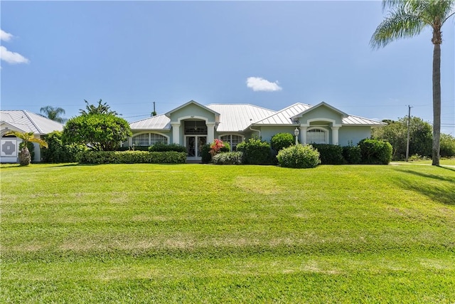 147 Empire Ter, Sebastian, FL 32958 - ranch-style home with metal roof, stucco siding, a standing seam roof, and a front lawn
