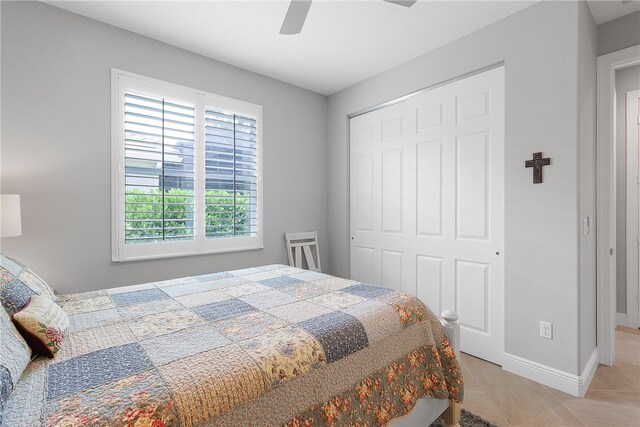 bedroom with light tile patterned flooring, ceiling fan, and a closet